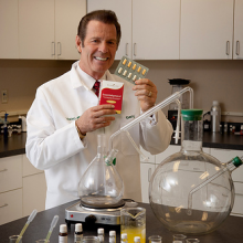 Gary Young displaying Essentialzyme product